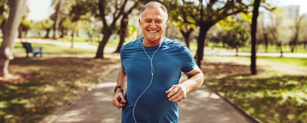 Active older adult enjoying a walk outdoors, staying pain-free during retirement