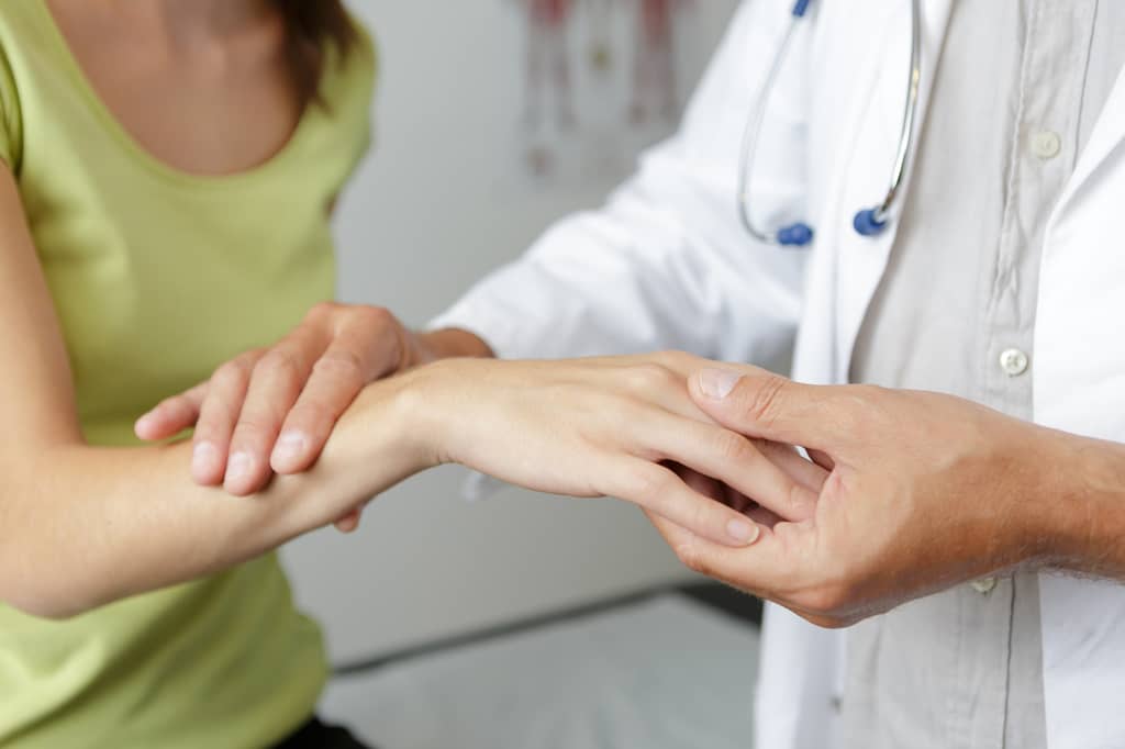 Hand surgeon examining a patient's wrist before private carpal tunnel surgery