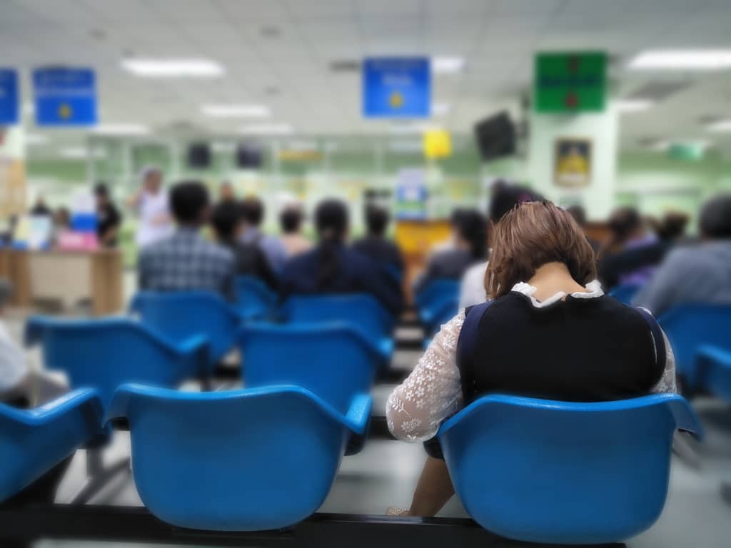 Patients waiting in an NHS hospital waiting room for their appointments