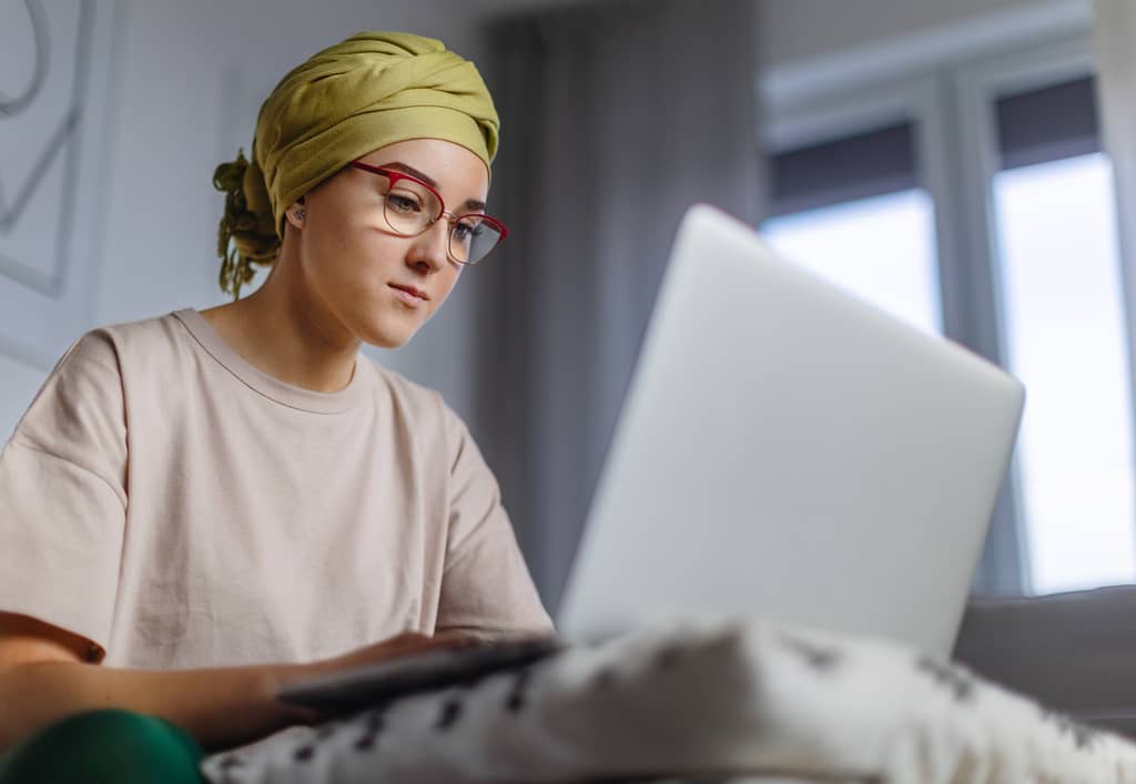 Young patient speaking with an oncologist during a cancer consultation in a UK hospital