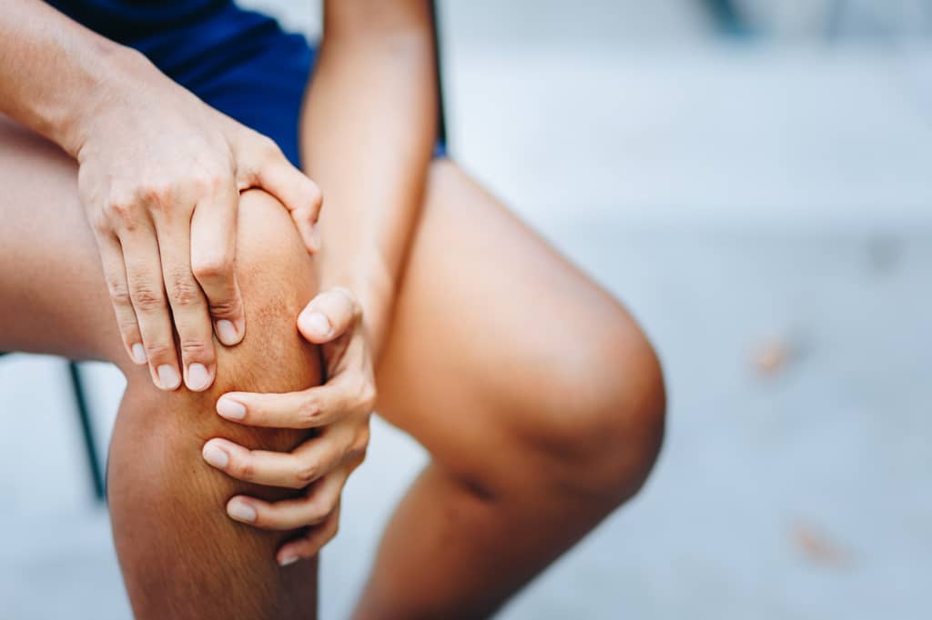Physiotherapist supporting a patient after private knee replacement surgery in the UK
