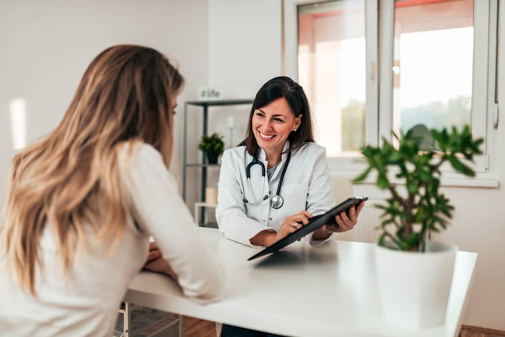 Patient researching a private medical consultant on a laptop at home in the UK