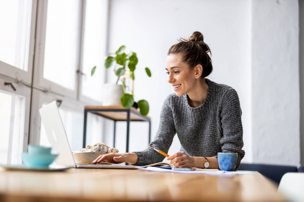 Person reviewing and updating their life insurance policy paperwork at home