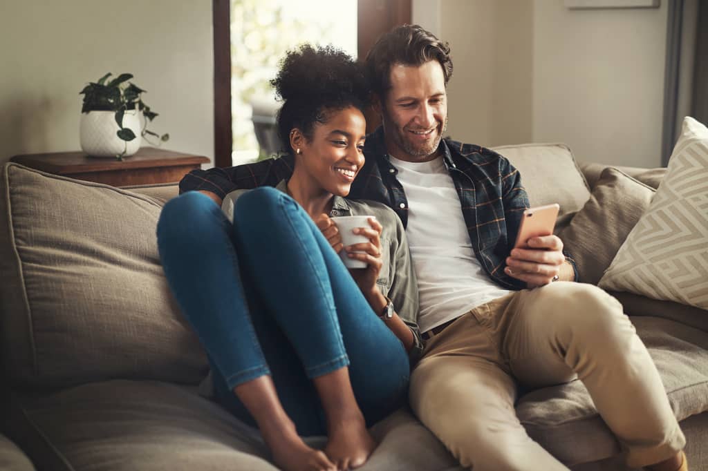 Couple reviewing mortgage life insurance alongside their home loan papers