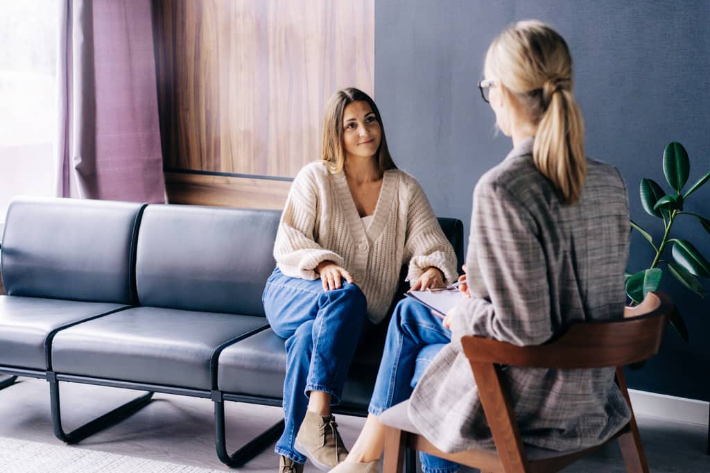 Person discussing life insurance options and depression with an adviser