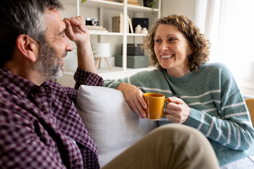 Couple in their fifties reviewing over 50s life insurance options at home