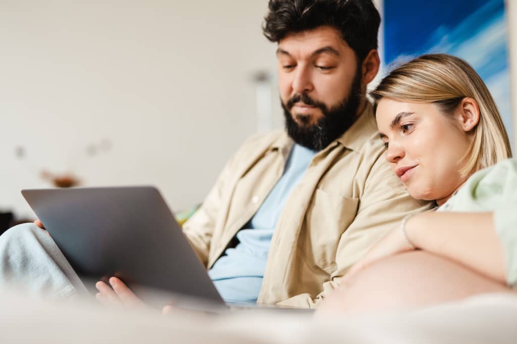 Couple reviewing life and critical illness cover options with an adviser